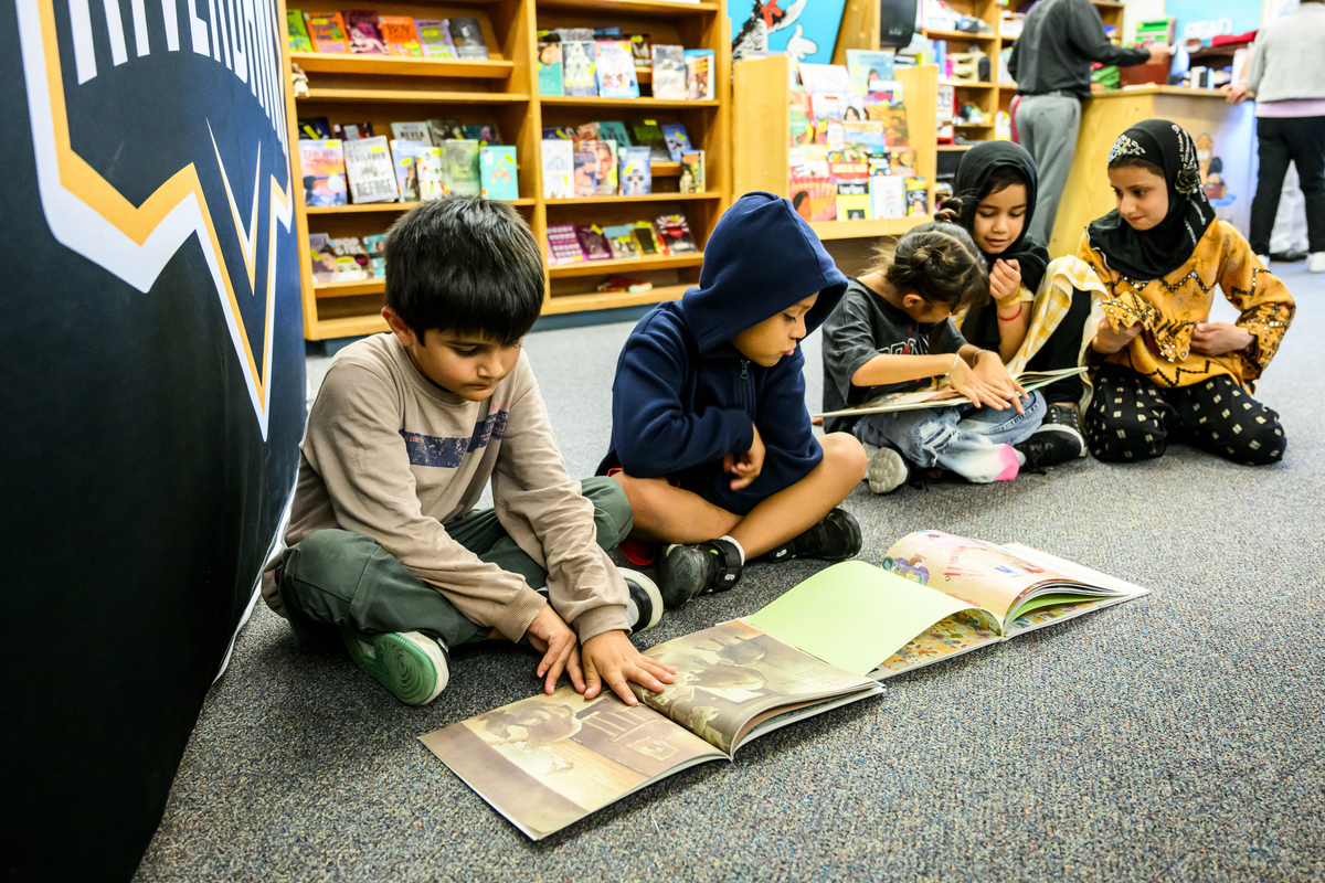 Children read new Farsi-language books in a school library.