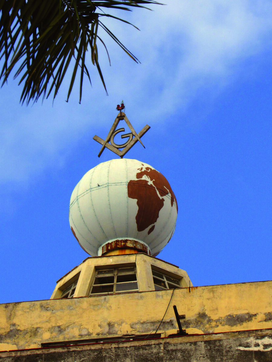A globe topped with a Masonic square and compass sits at the top of the Grand Lodge building in Havana, Cuba.