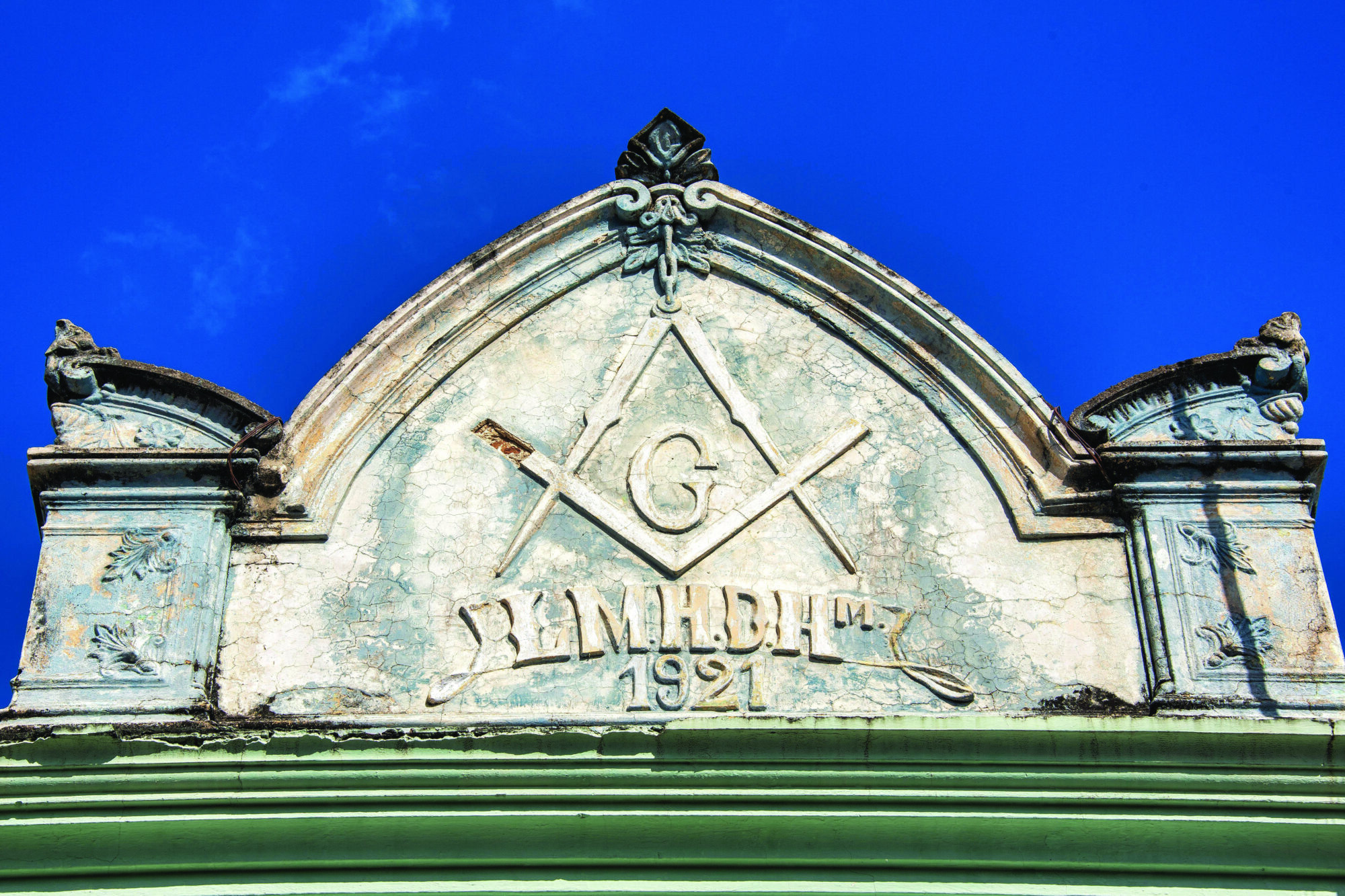 Masonic symbols are visible in the weathered architecture of the Hijos de Hiram Masonic lodge in Las Tunas, Cuba. Photo by Alamy.